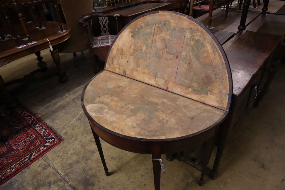 A George III mahogany D shape folding tea table, width 91cm depth 45cm height 75cm